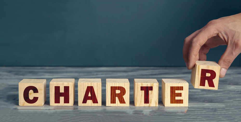 the word 'Charter' spelled out with large wooden blocks