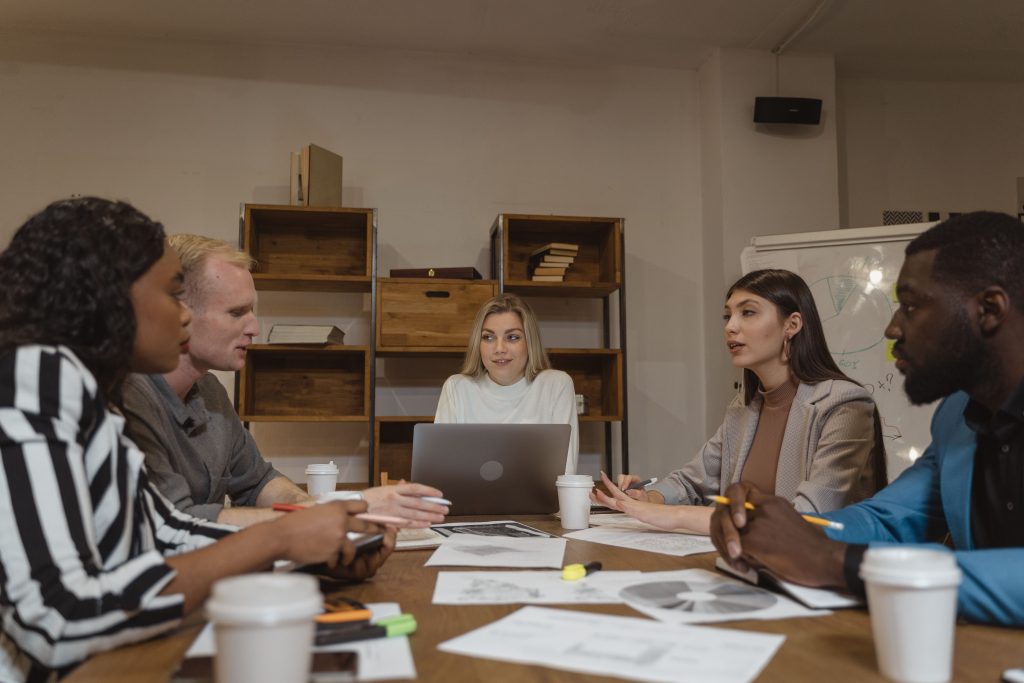 Group of professionals collaborating in a modern office setting during a strategic meeting